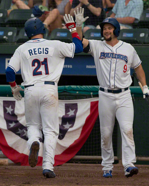 Cody Regis high fives Conrad Gregor in a Rockland Boulders' win