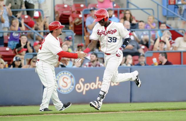 Spokane Indians outfielder Starling Joseph receives congratulations while rounding third