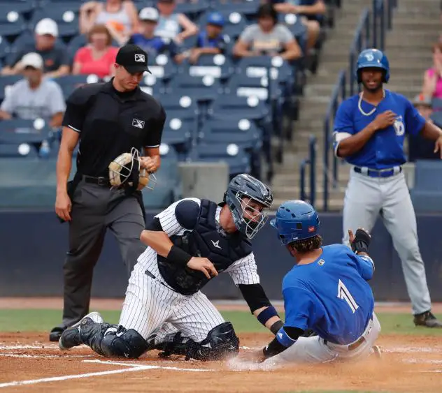 Tampa Tarpons catcher Donny Sands applies the tag