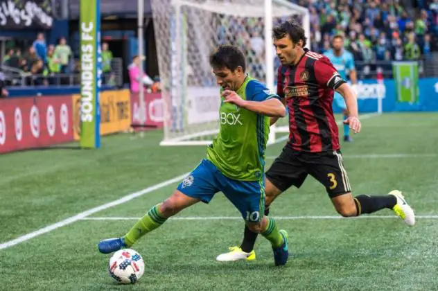 Seattle Sounders FC's Nico Lodeiro and Atlanta United's Michael Parkhurst face off