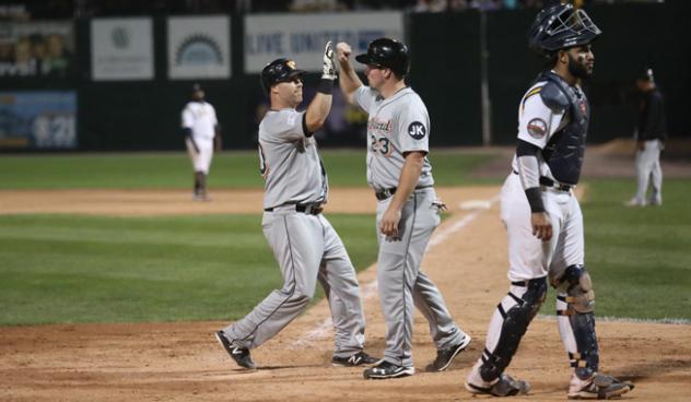 Lew Ford and Travis Snider of the Long Island Ducks exchange high fives