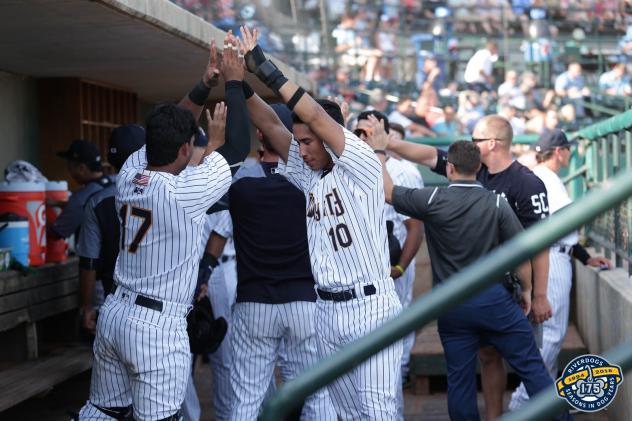 Charleston RiverDogs teammates give shortstop Oswaldo Cabrera high fives