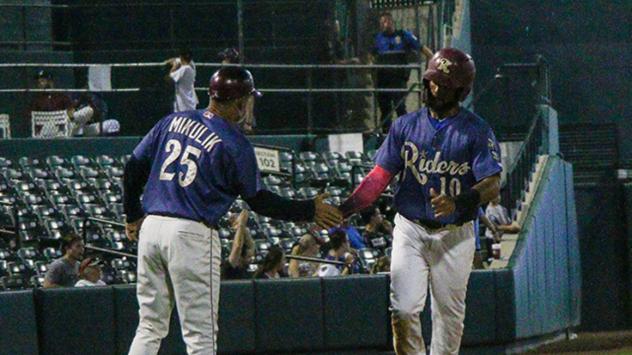 Frisco RoughRiders center fielder Eliezer Alvarez (10) receives congratulations while rounding the bases