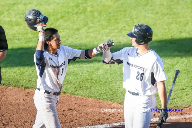 Victoria HarbourCats' Nick Plaia (left) is congratulated by Hunter Vansau (right) after Plaia's home run