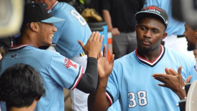 Hickory Crawdads 1B Tyreque Reed receives high fives in the dugout
