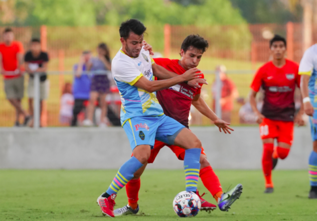 Las Lights FC's Carlos Alvarez (left) battles for possession against Rio Grande Valley FC