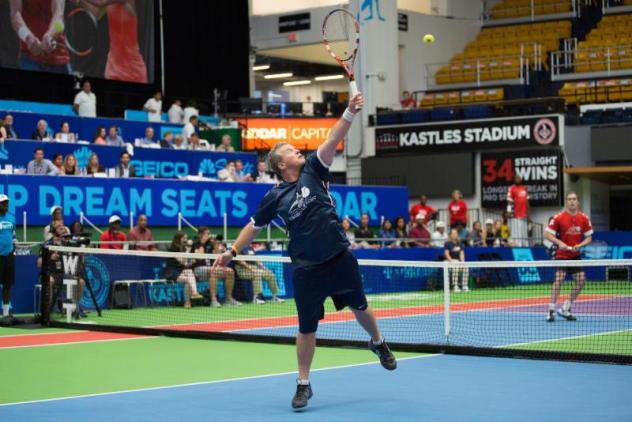 Former Rep. Charlie Dent (R-PA) hits an over the head, behind the back volley in his first set performance
