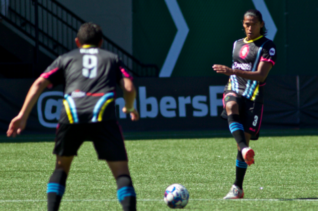 Las Vegas Lights FC defender Joel Huiqui (right) moves possession