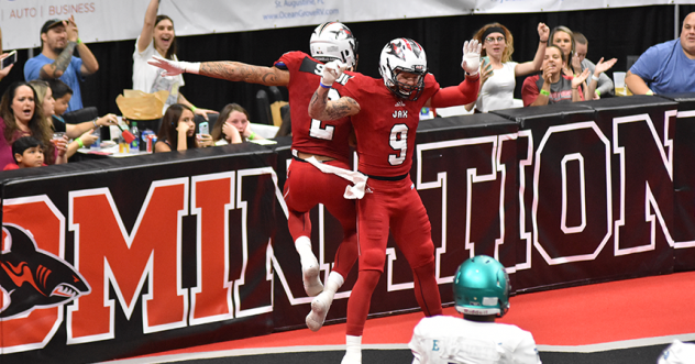 Jacksonville Sharks' Cody Saul, Tom Gilson (9) and fans celebrate a touchdown
