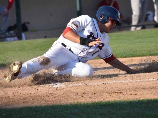 Ramon Flores of the Somerset Patriots slides home