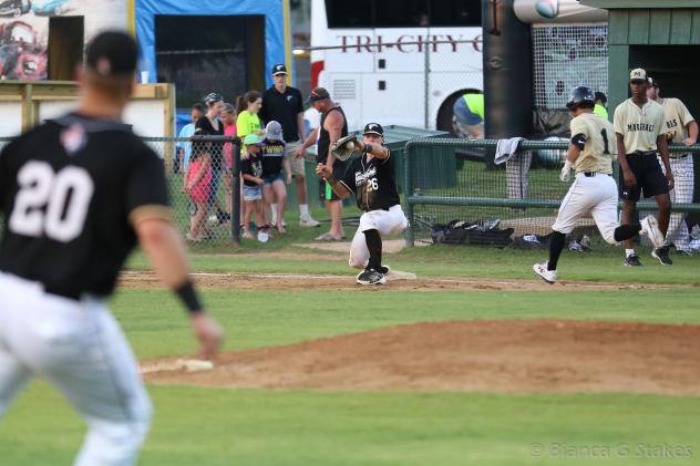 Texarkana Twins complete a throw to first for an out
