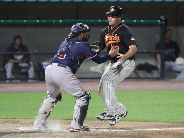 Somerset Patriots catcher Yovan Gonzalez stops the Long Island Ducks