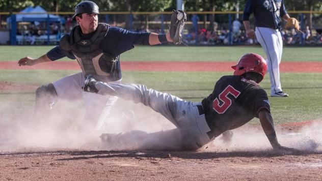 Vancouver Canadians SS Otto Lopez slides safely into home