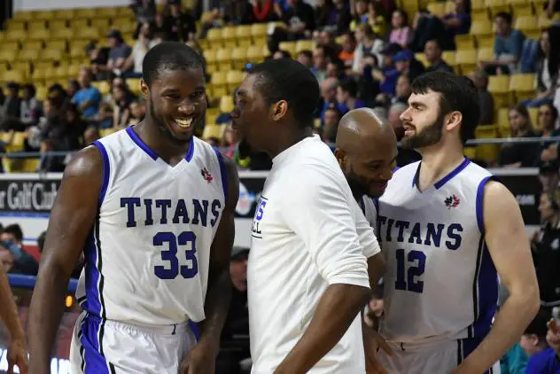 Flenard Whitfield and the KW Titans bench share a laugh