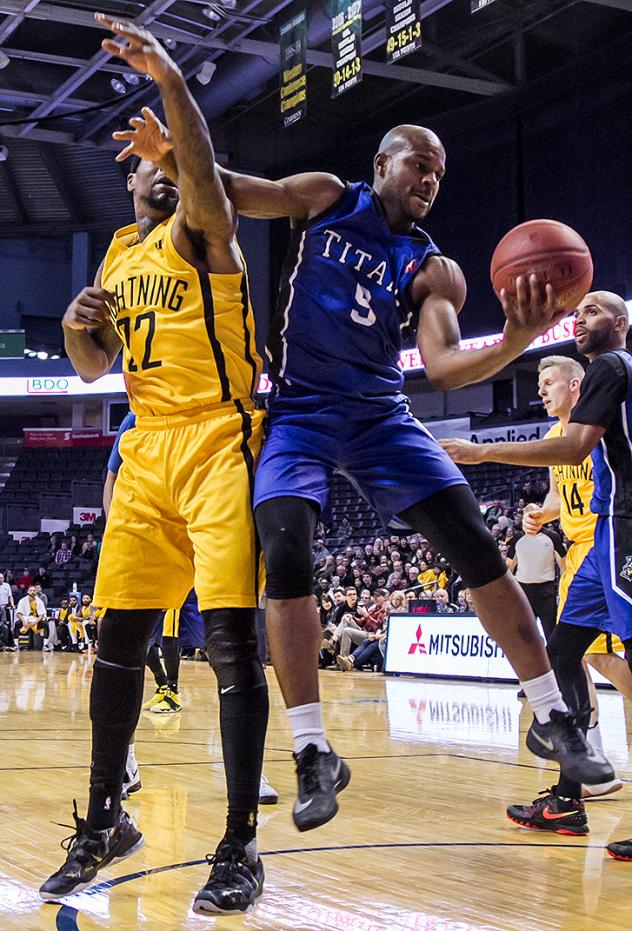 Kitchener-Waterloo Titans SG/SF Tramar Sutherland battles for the ball against the London Lightning