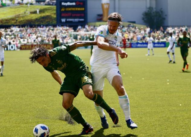 Zarek Valentin of the Portland Timbers and Gustav Svensson of Seattle Sounders FC