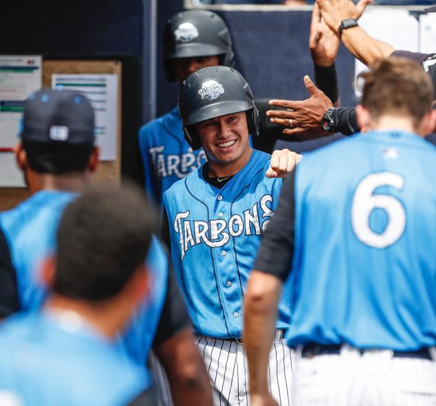 Diego Castillo of the Tampa Tarpons receives congratulations in the dugout