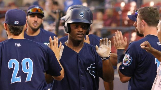 Everett AquaSox exchange high fives after a Game Two win
