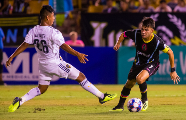 Las Vegas Lights FC's Carlos Alvarez (right) works around his younger brother, LA Galaxy II's Efrain Alvarez