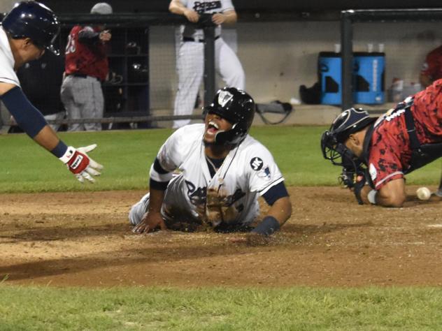 Justin Trapp slides home with the winning run for the Somerset Patriots