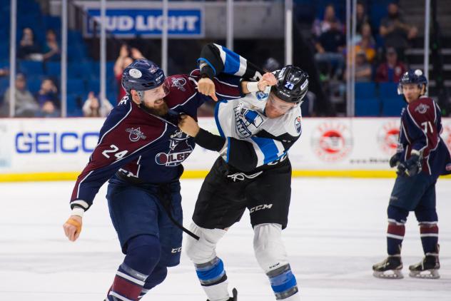 Tulsa Oilers defenseman Mike McKee (left) mixes it up