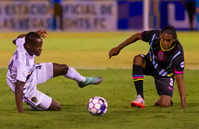 Las Vegas Lights FC defender Joel Huiqui (right) fights for possession against LA Galaxy II