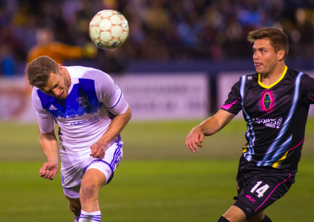 Las Vegas Lights FC midfielder Alex Mendoza (right) fights for possession against Reno 1868 FC