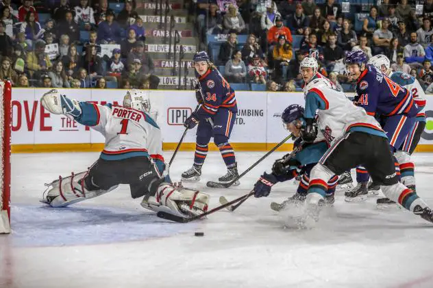 Kelowna Rockets goaltender James Porter scrambles to keep the puck out of the net against the Kamloops Blazers