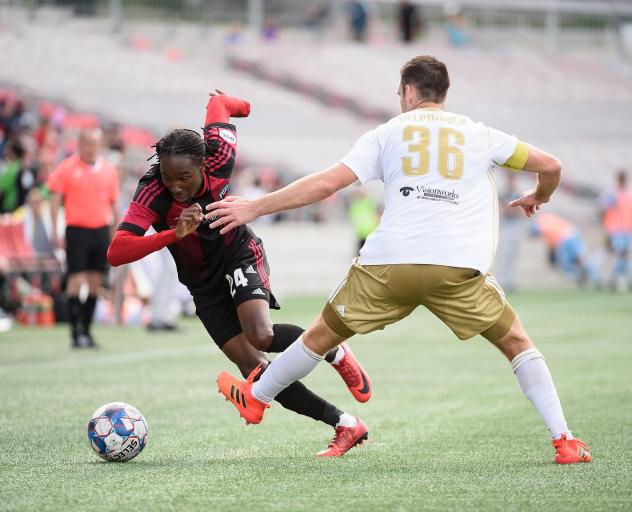 Ottawa Fury FC race to the ball vs. Louisville City FC