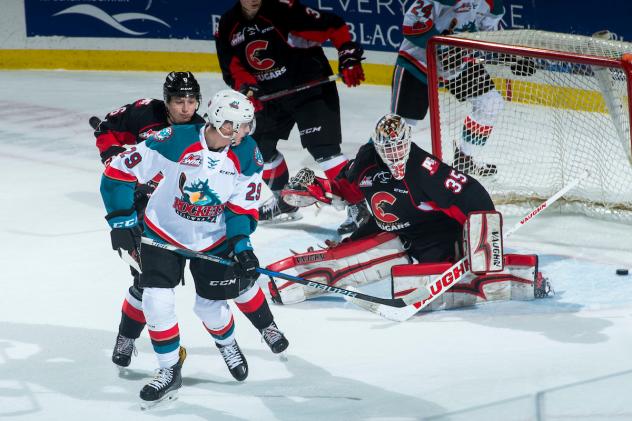 Kelowna Rockets slip the puck past the Prince George Cougars