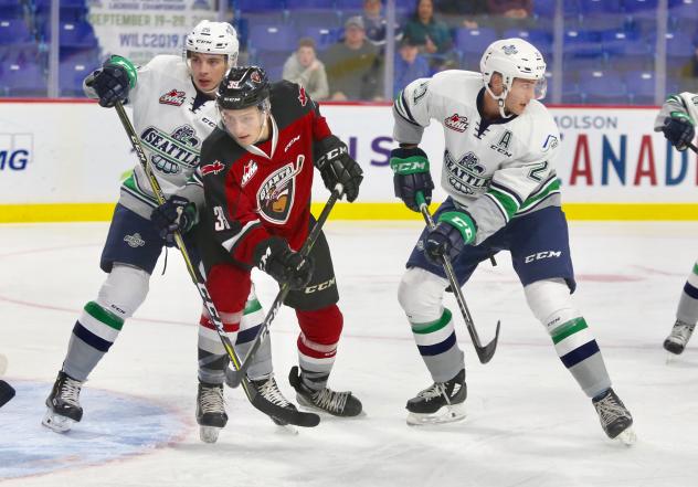Vancouver Giants forward Evan Patrician battles the Seattle Thunderbirds