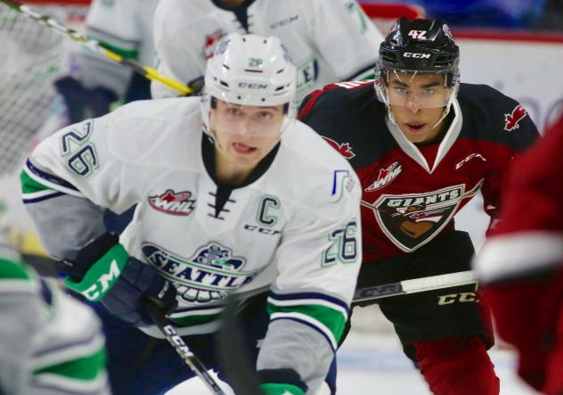 Seattle Thunderbirds forward Nolan Volcan and Vancouver Giants forward Justin Sourdif