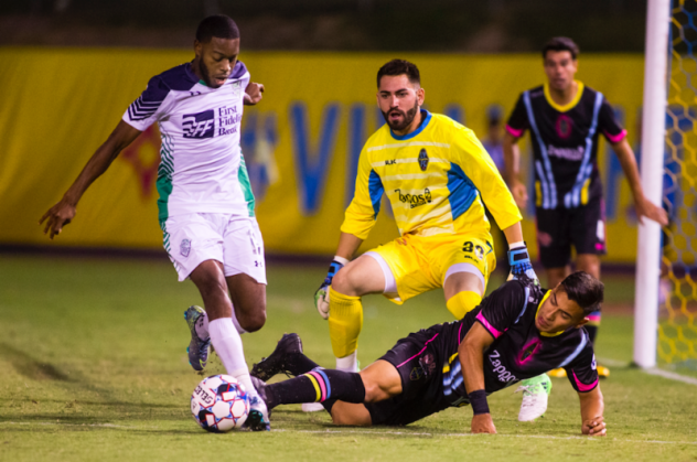 Las Vegas Lights FC's Thomas Olsen (in yellow) and Joseph Patrick Perez vs. OKC Energy FC