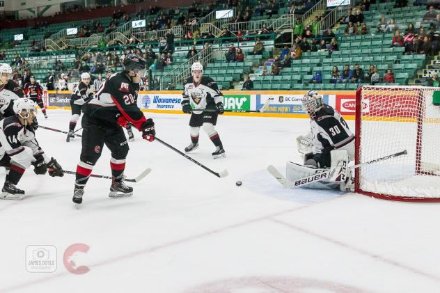 Vancouver Giants goaltender David Tendeck fends off the Prince George Cougars