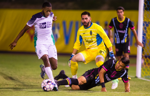 Las Vegas Lights FC goalkeeper Thomas Olsen (yellow) tracks action vs. OKC Energy FC