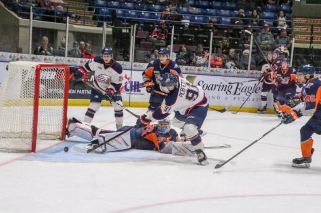 Cole Perfetti of the Saginaw Spirit scores against the Flint Firebirds