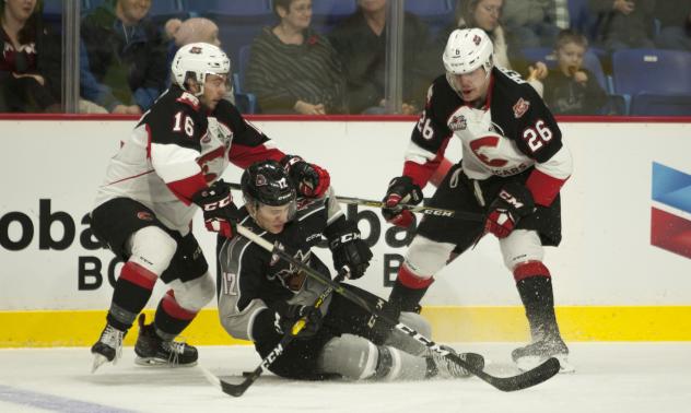 Vancouver Giants RW Cyle McNabb is taken down by the Prince George Cougars