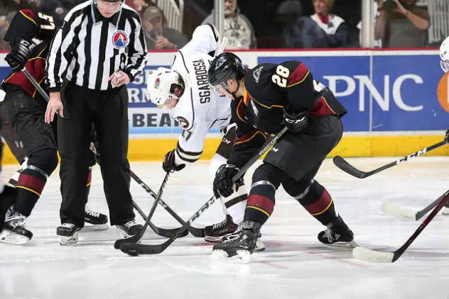 Cleveland Monsters C Zac Dalpe battles for the puck against the Hershey Bears