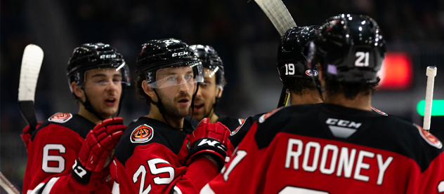 Binghamton Devils exchange congratulations after a goal