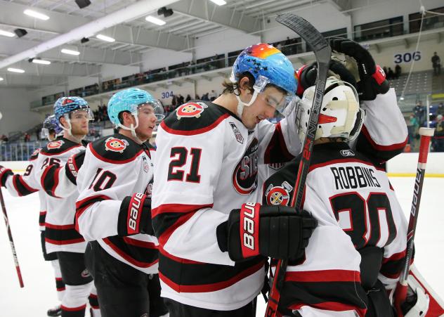 Chicago Steel exchange congratulations while wearing specially designed helmets