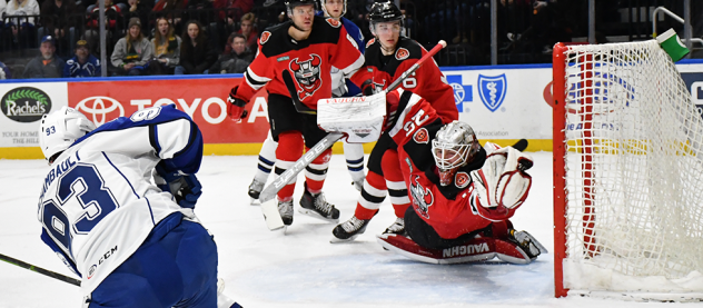 Binghamton Devils goaltender Mackenzie Blackwood dives to stop a Syracuse Crunch shot