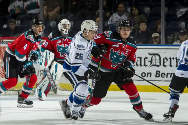 Kelowna Rockets LW Nolan Foote (right) holds off the Victoria Royals