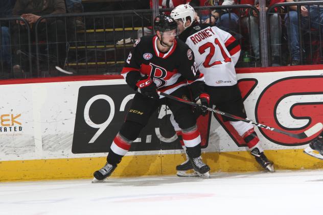 Binghamton Devils center Kevin Rooney (right) battles against the Belleville Senators