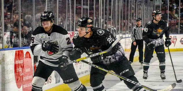 Utah Grizzlies defenseman Gage Ausmus (right) prepares to deliver a hit