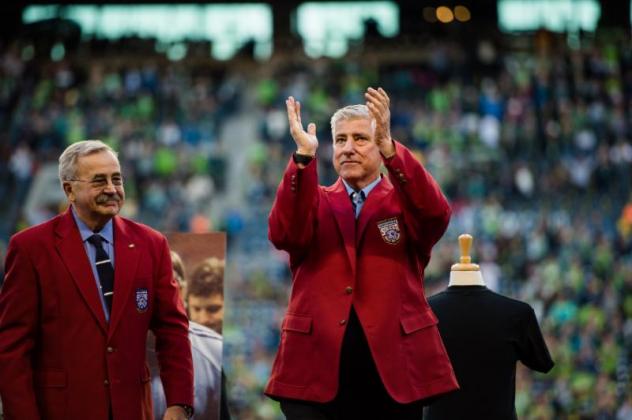 Sigi Schmid acknowledges the crowd at CenturyLink Field while donning his jacket from the National Soccer Hall of Fame on October 4, 2015