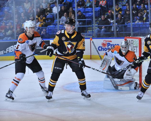 Lehigh Valley Phantoms D Philippe Myers (left) vs. the Wilkes-Barre/Scranton Penguins while goaltender Alex Lyon keeps a watchful eye