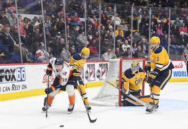 Flin Firebirds center Kyle Harris works behind the Erie Otters goal