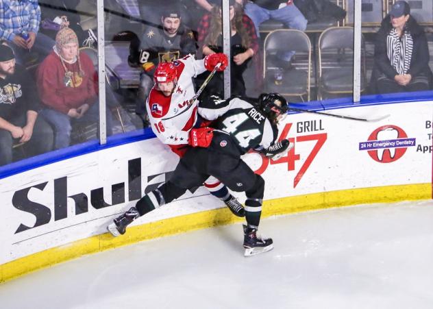 Utah Grizzlies forward RT Rice knocks an Allen American up against the boards