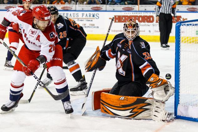Allen Americans center Spencer Asuchak slips one by the Kansas City Mavericks goaltender