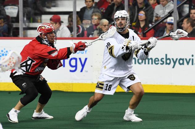 Logan Schuss of the Vancouver Warriors (right) vs. the Calgary Roughnecks